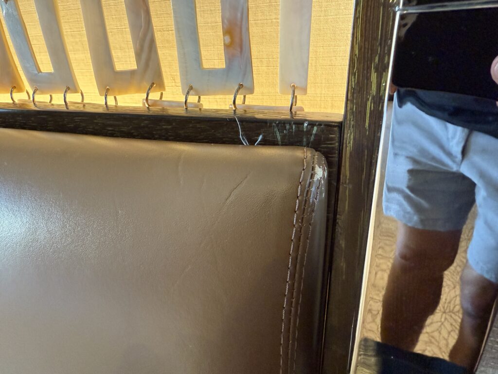 A ding in the corner of the leather headboard.