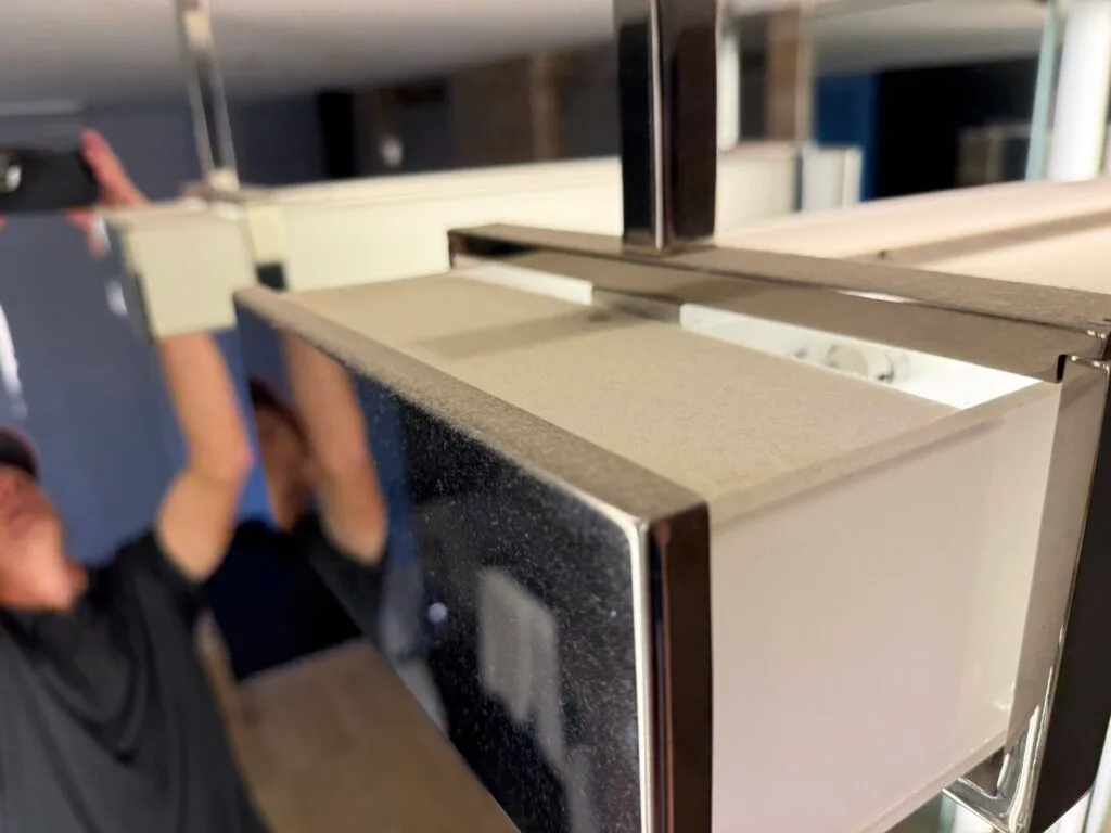 A light fixture with a light coating of dust atop it. 