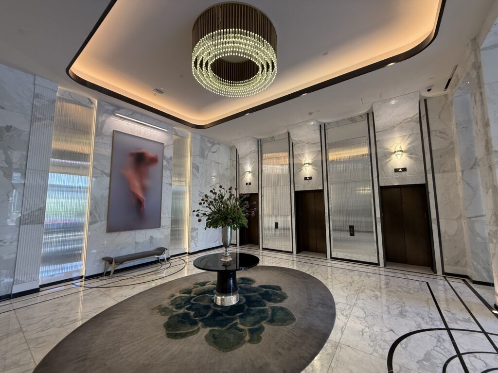 The elevator lobby on the main floor, with 3 black elevator doors.