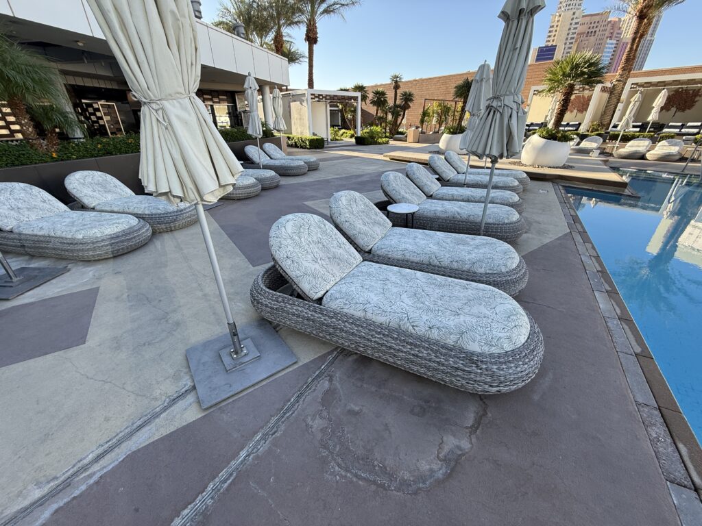 A row of wicker loungers with thick padding.