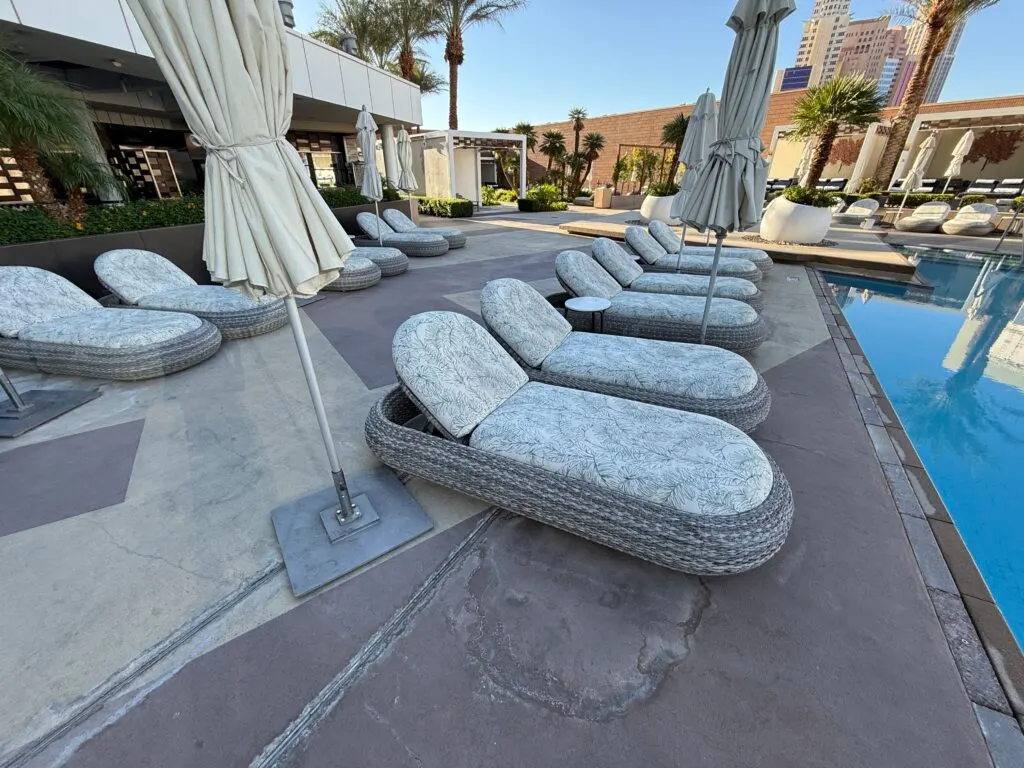 A row of wicker loungers  with thick padding. 