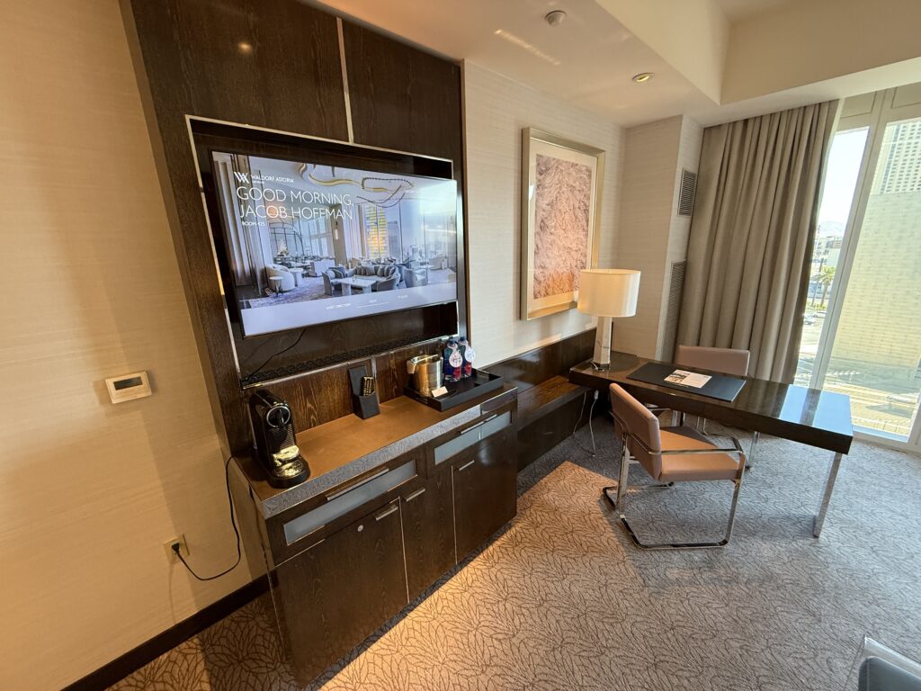 The entertainment station, with a mounted TV, and a workdesk protruding out at a 90-degree angle.