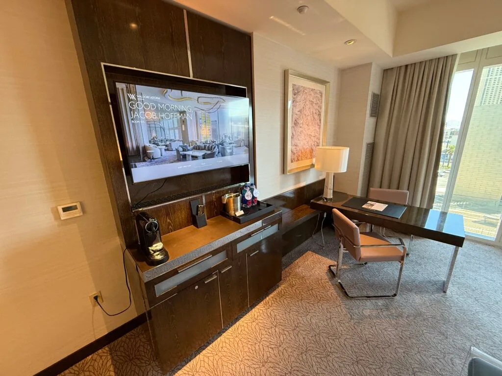 The entertainment station, with a mounted TV, and a workdesk protruding out at a 90-degree angle. 