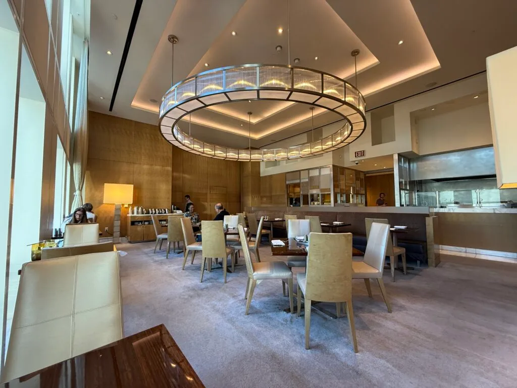 Zen Kitchen, with tables scattered about and a large, circular light fixture overhead. 