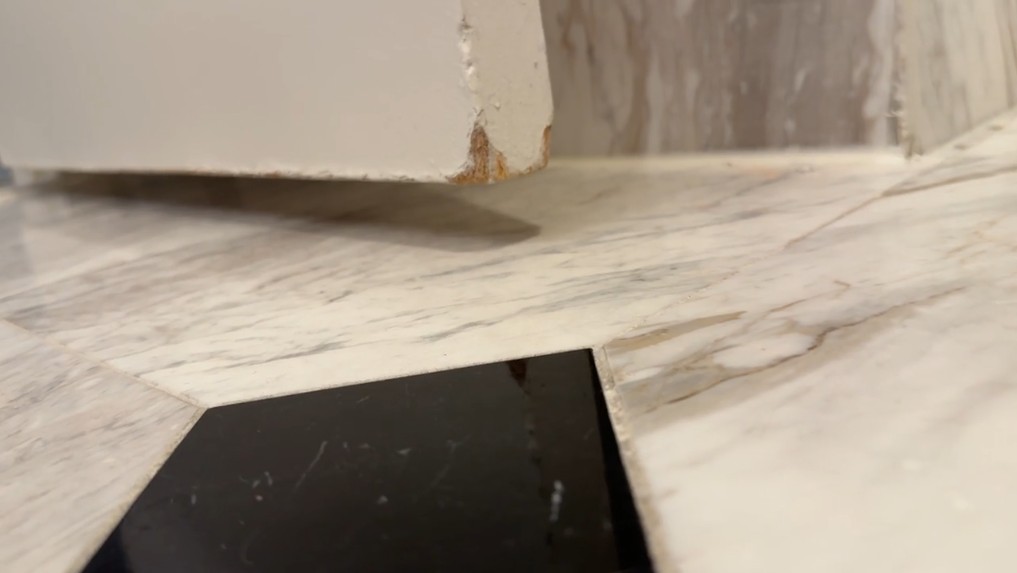 A beat up door corner in the bathroom.