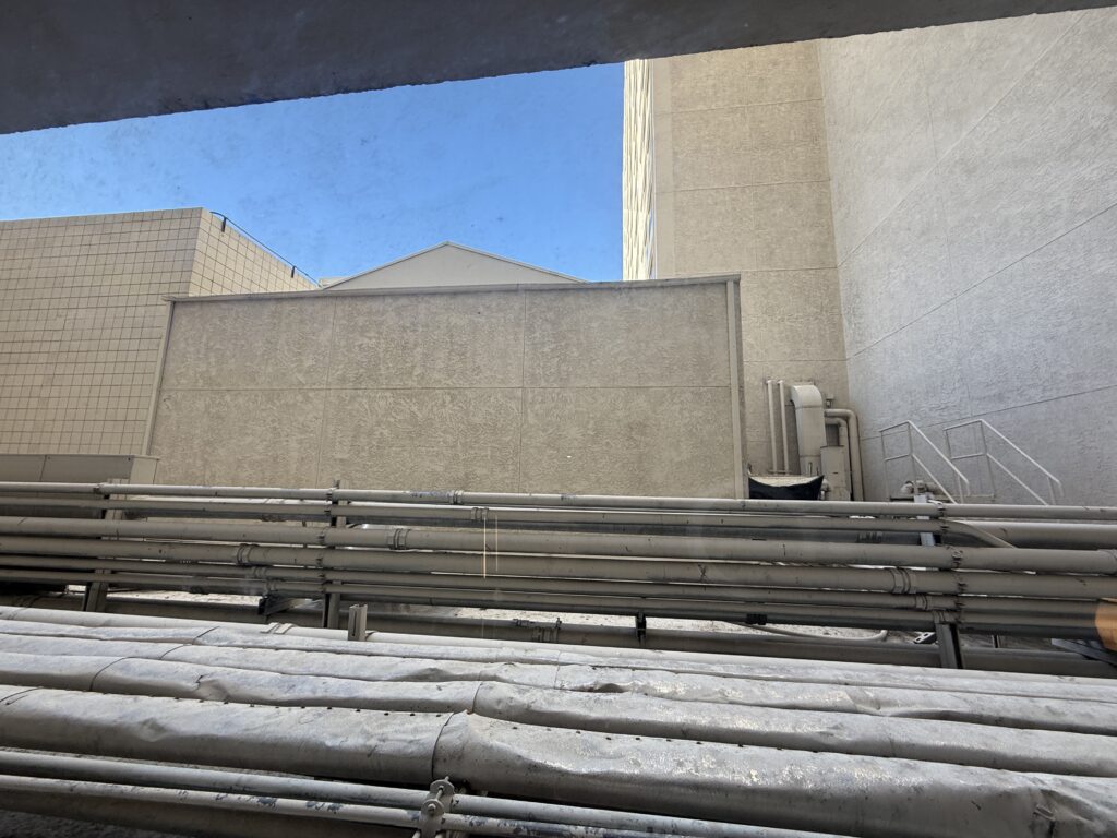 A terrible view of Harrah's rooftop, piping, and garbage.