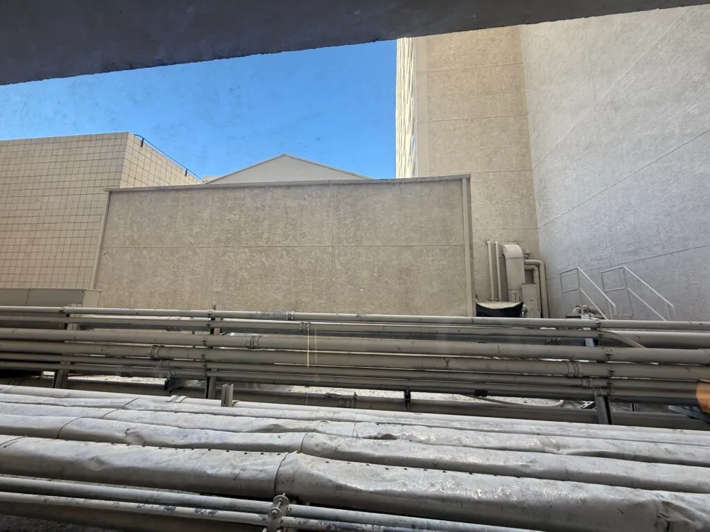 A terrible view of Harrah's rooftop, piping, and garbage. 