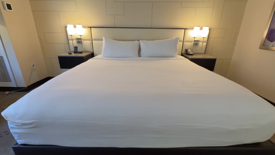 A king bed, shot from the foot of the bed.