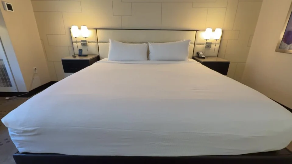 A king bed, shot from the foot of the bed. 