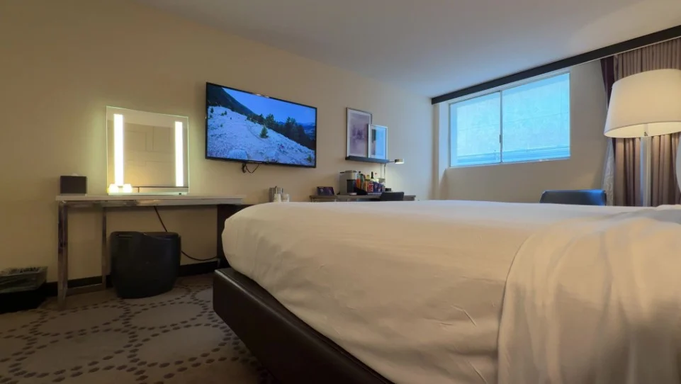 A view of the TV and the illuminated vanity on the workdesk. 