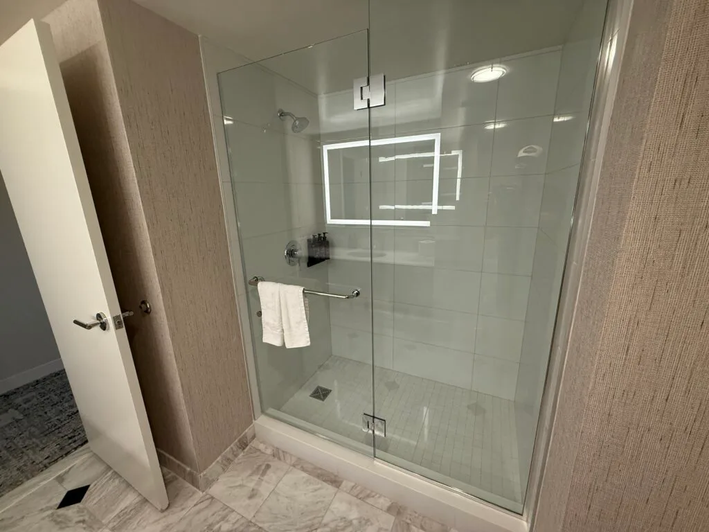 The shower, which had a full glass wall. 