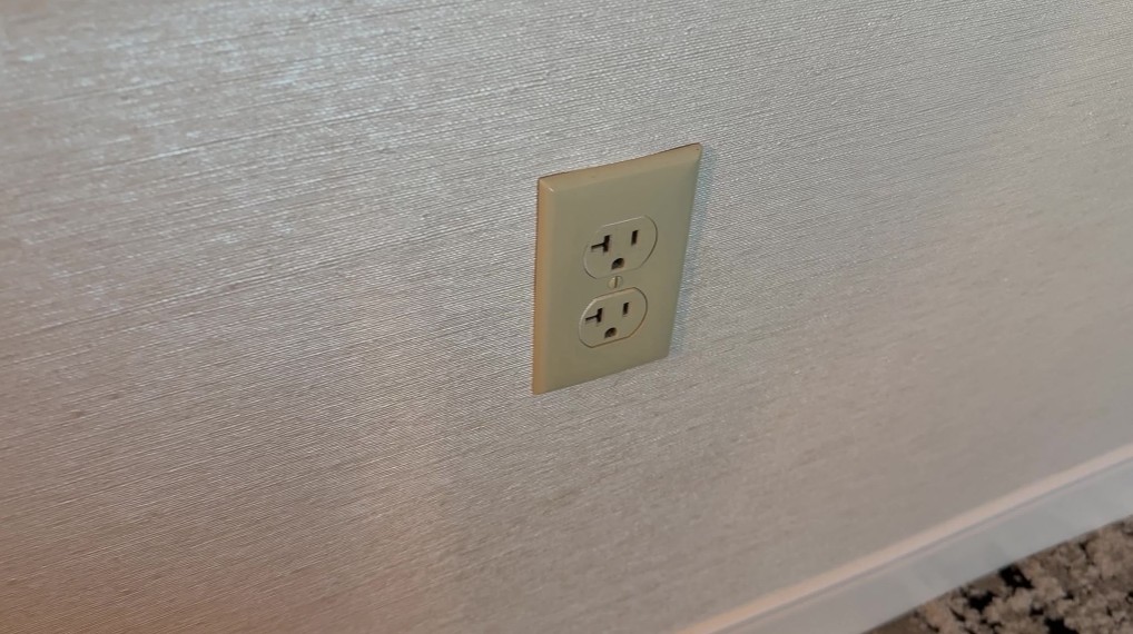 A yellowed, aging wall outlet.