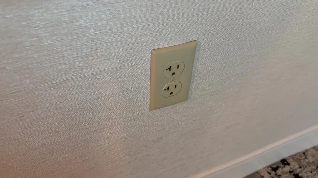A yellowed, aging wall outlet. 