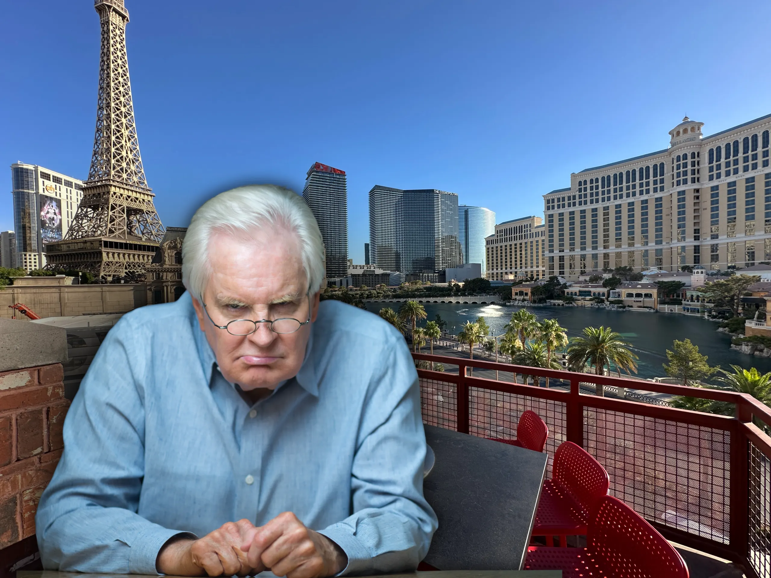A very grumpy old man staring into the camera with Vegas resorts in the background.
