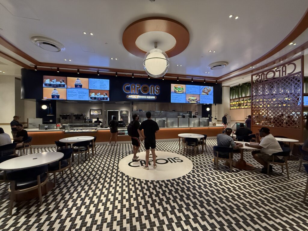 Capons ordering counter, menu board, and seating. 