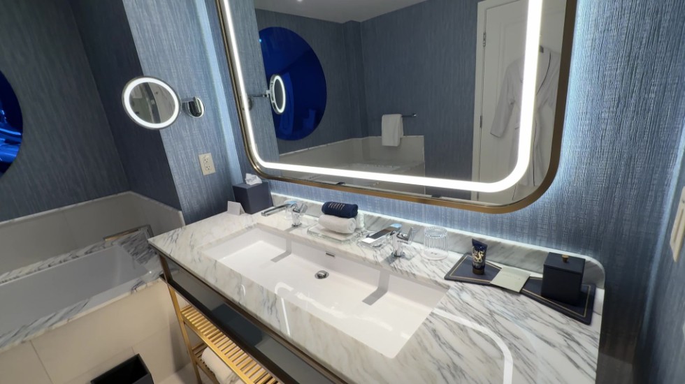 A long, rectangular sink with one drain and two faucets.