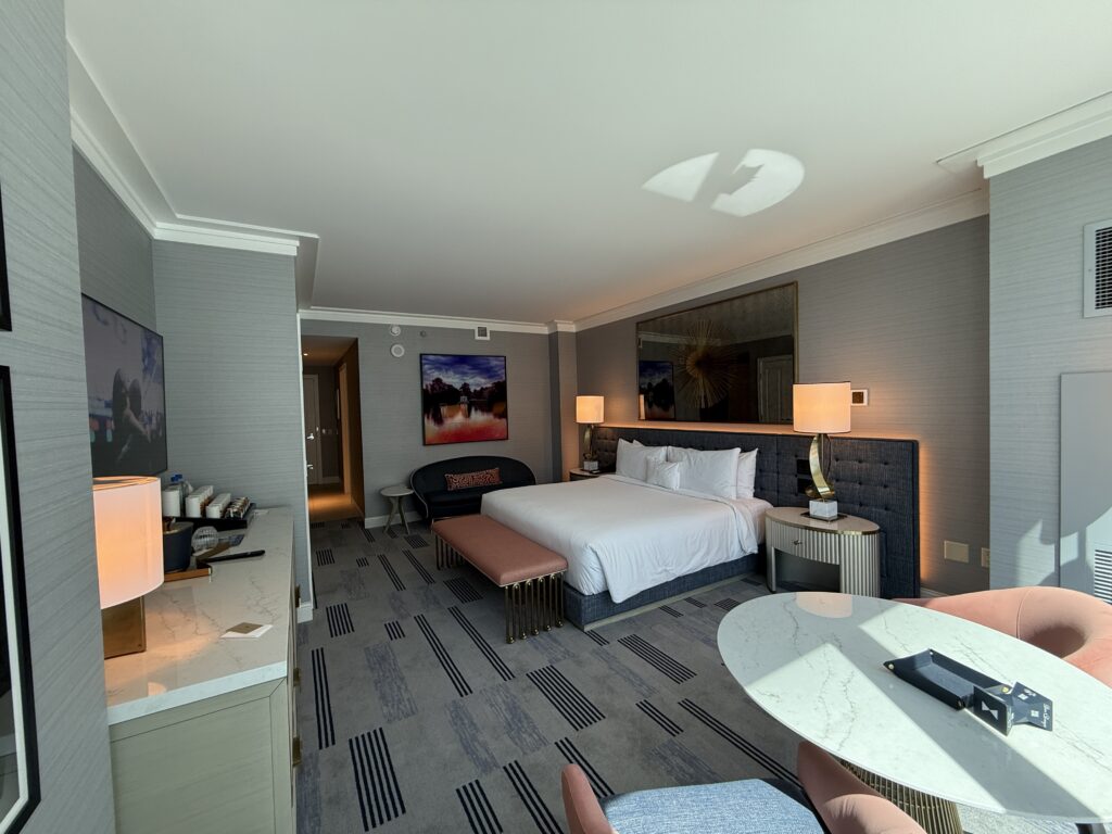 Another angle, which shoes the bed flanked by two lamps. The headboard is illuminated from behind.