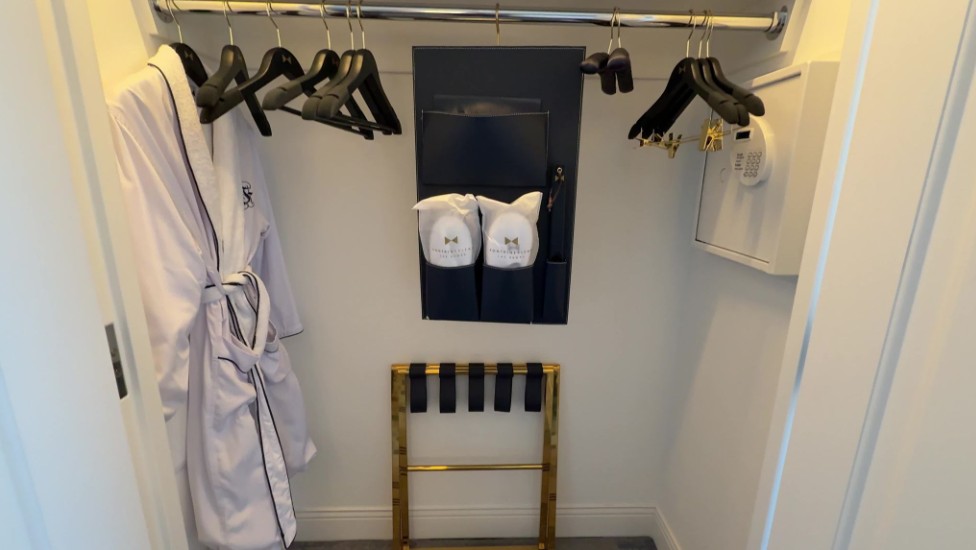 Slippers and roves hang in the closet.