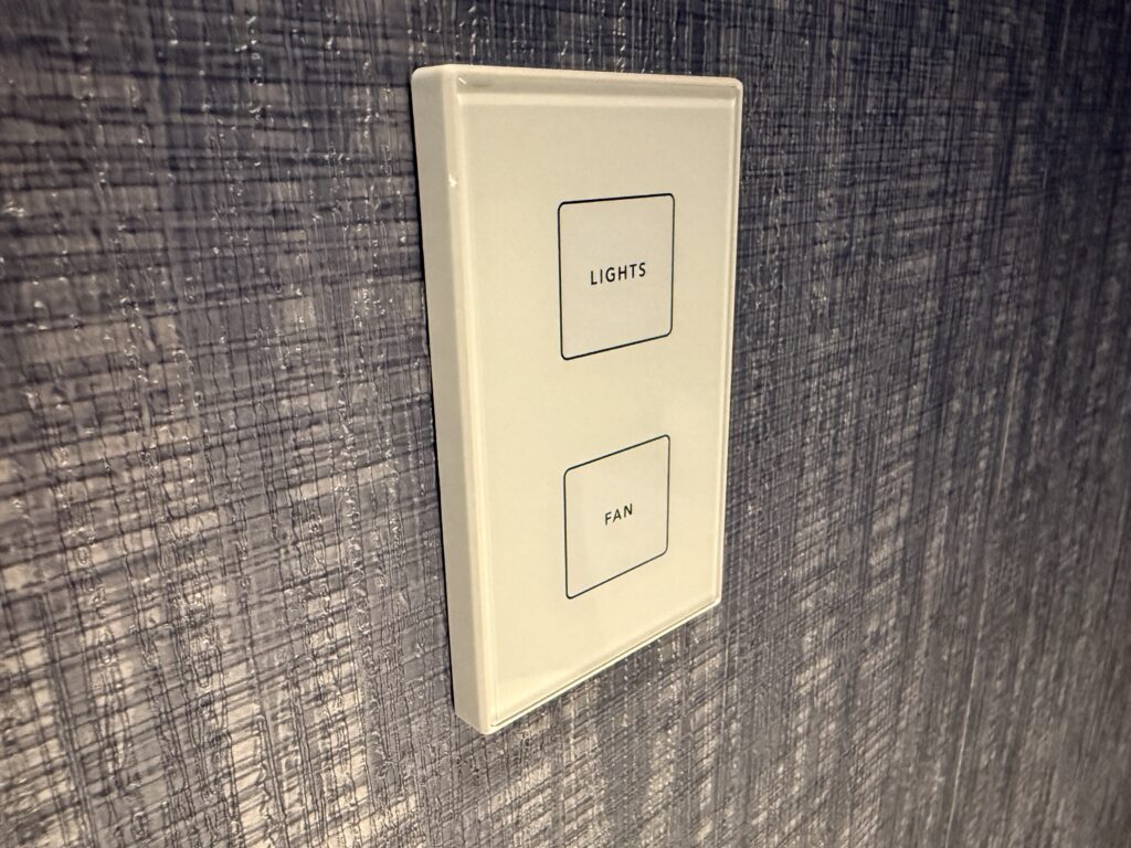 A digital control in the water closet that allows you to turn on the fan. 