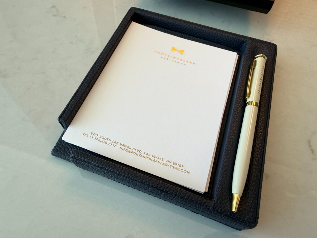A pad of FB stationary in a leather holder with a pen. 