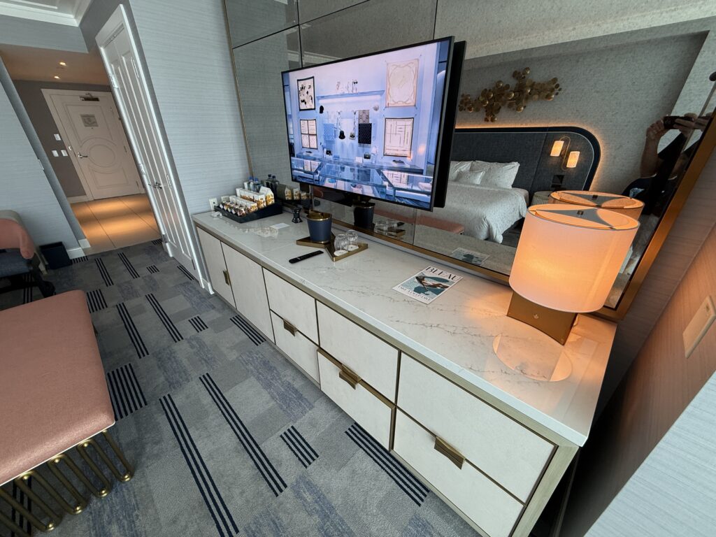 The TV stand, with a dry mini bar atop it. 