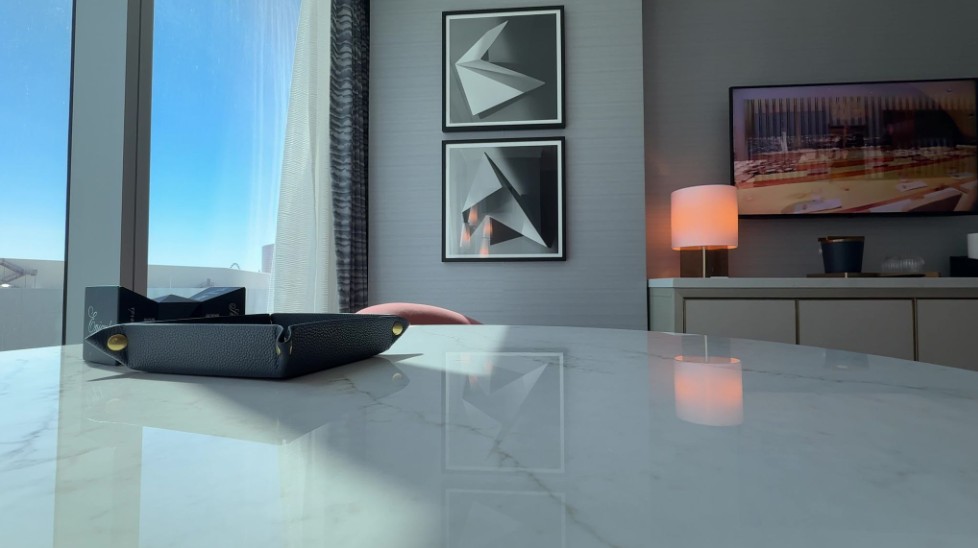 A view from the window side table of artwork and the TV.