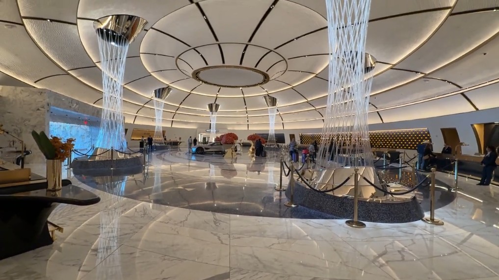 The hotel lobby, which has marble floors, illuminated pillars, and an elegant vibe.