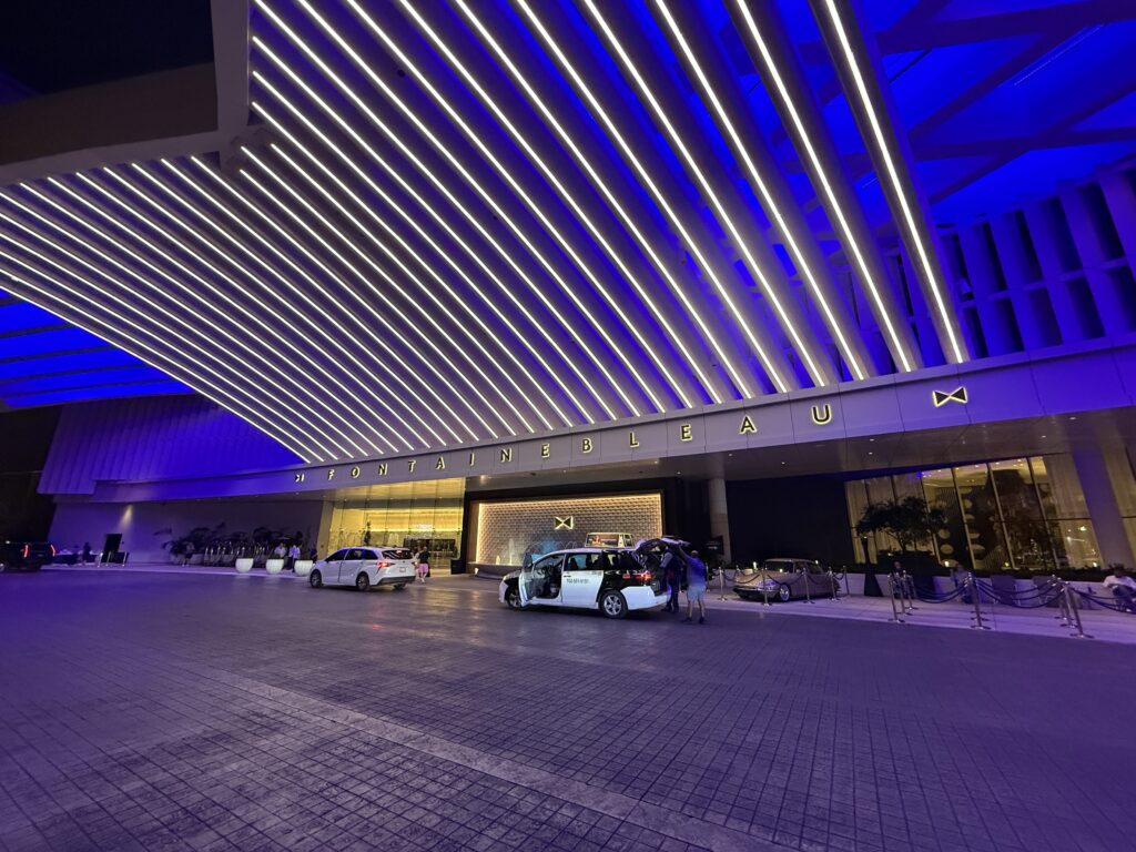 Fontainebleau's porte cochere illuminated at night. 