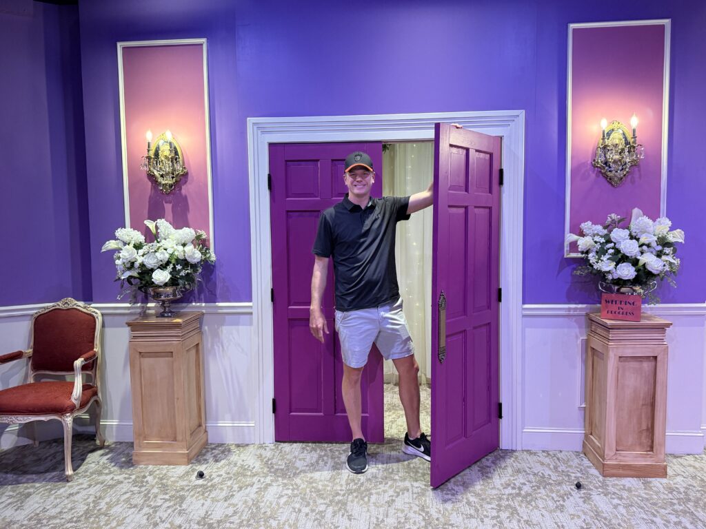 Me posing near a purple wedding chapel door. 