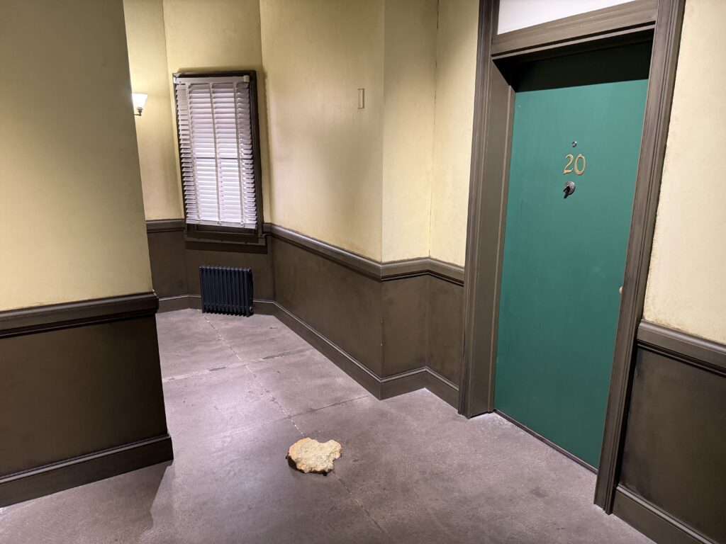 A splatted cheesecake on an apartment complex floor. 