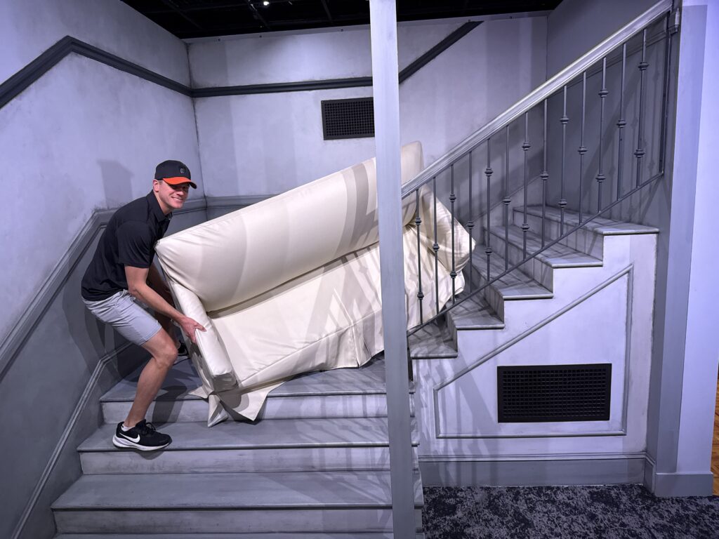 Me, posing with a couch halfway up a stairwell. 