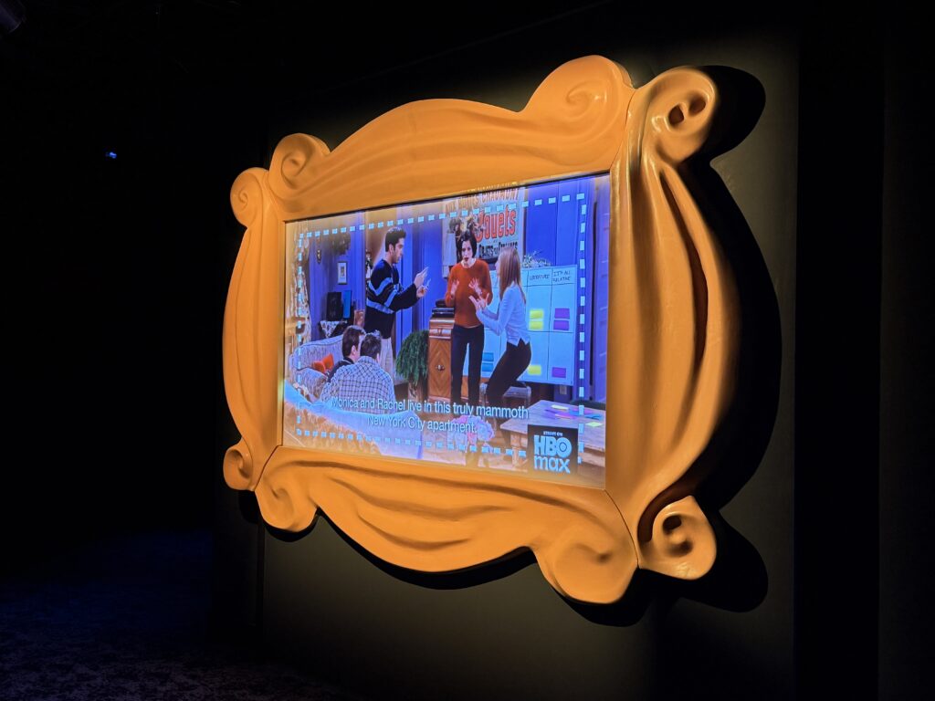 A TV playing the show Friends as an intro video. 