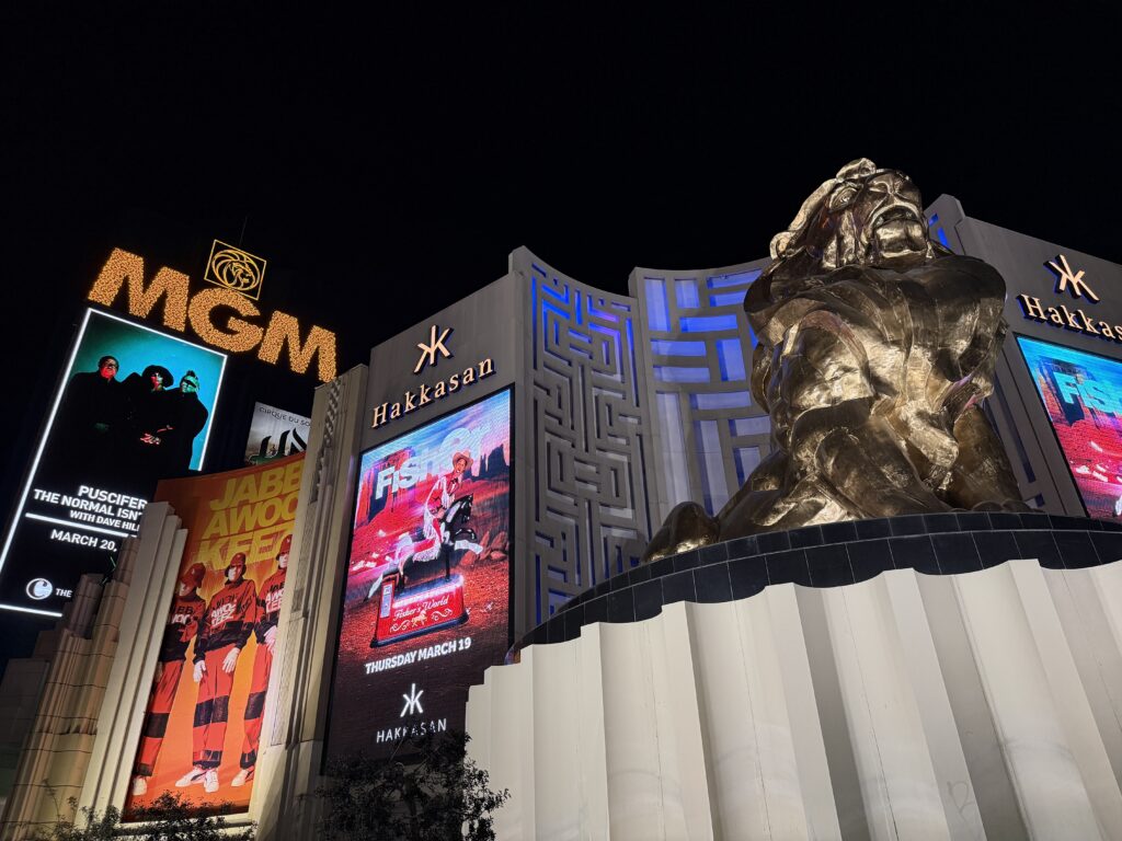 MGM Grand's Exterior sign and iconic golden lion statue against a night sky.