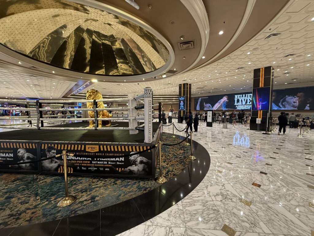 MGM Grand's hotel lobby, with a golden lion statue in the middle of a boxing ring. 