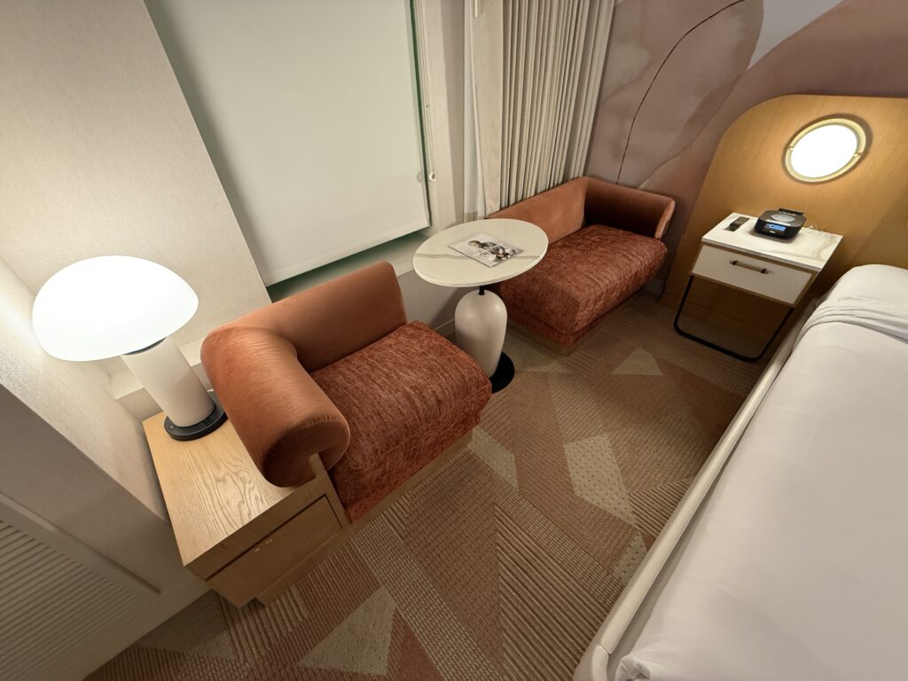 seating next to the bed and underneath the window, which was pink. 