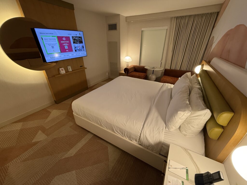 A view of the King bed pointing to the TV mounted on the wall. 