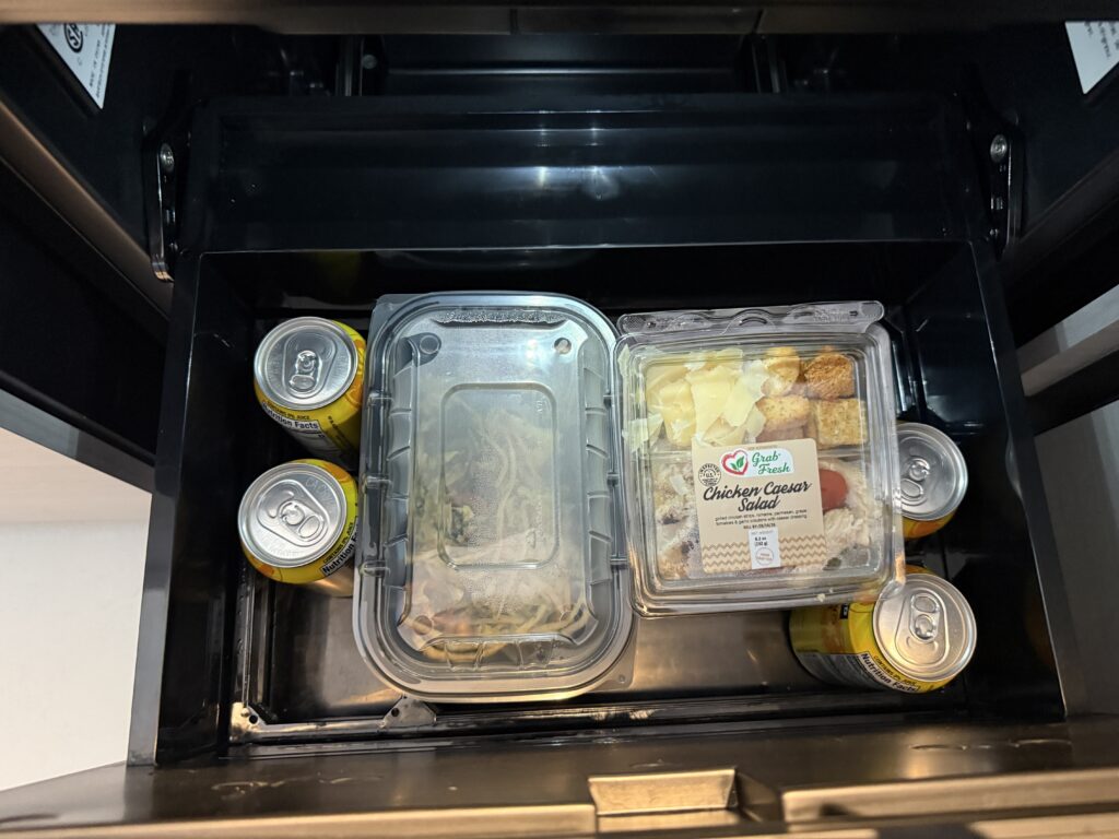 A chilling drawer, open, to show food and drinks that were left from the previous occupant. 