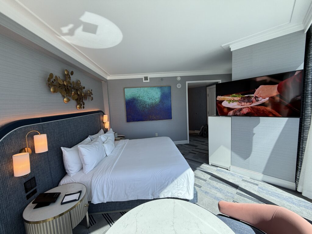 Another angle of the bedroom, which shows the king bed pointed at a mounted TV. 
