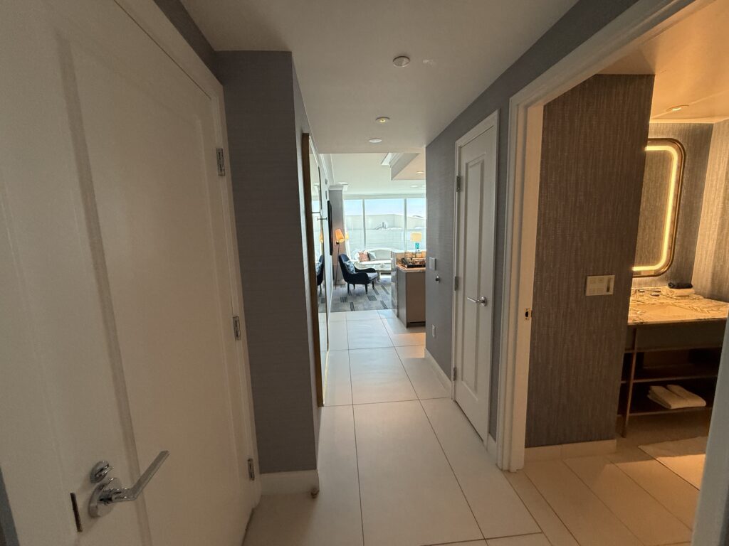 The entry hallway to the suite, which shows a bathroom to the right. 