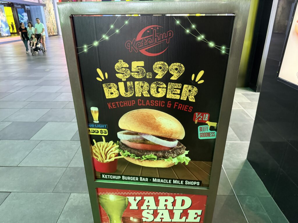 A sign outside the restaurant advertising the $5.99 burger deal.