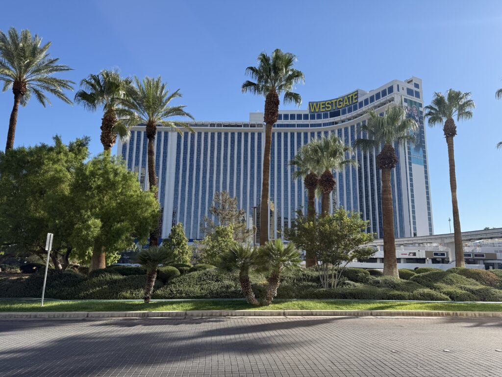 The exterior of Westgate's hotel tower with palm trees in the foreground.
