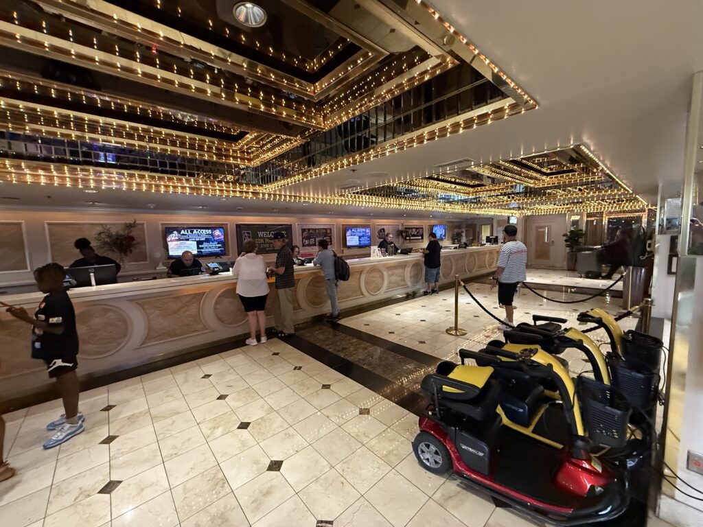 Hotel registraiton desk at 4 Queens, with a fleet of motorized scooters parked in front of it.