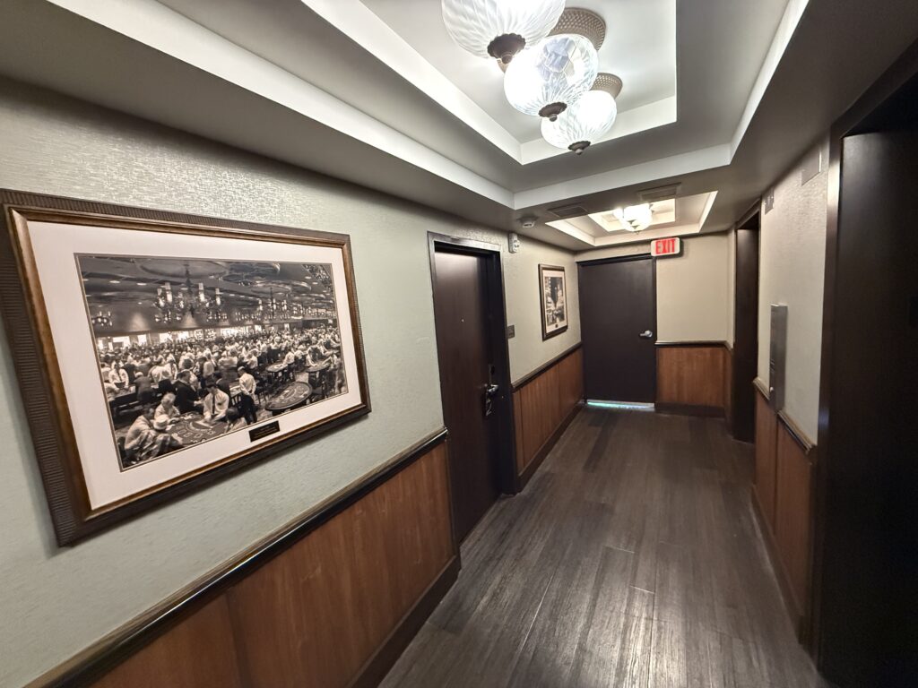 The elevator lobby on my floor, which is small, but has hardwood floors and 2 historic pictures of the property.