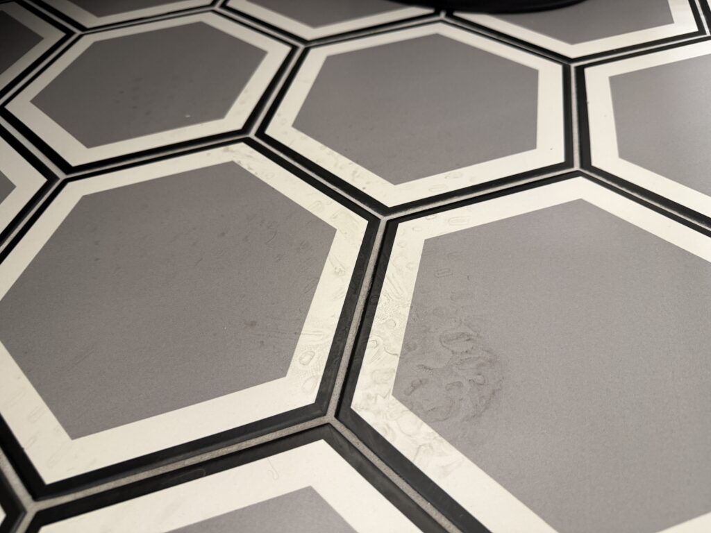 Footprints or grime on the bathroom fllor.