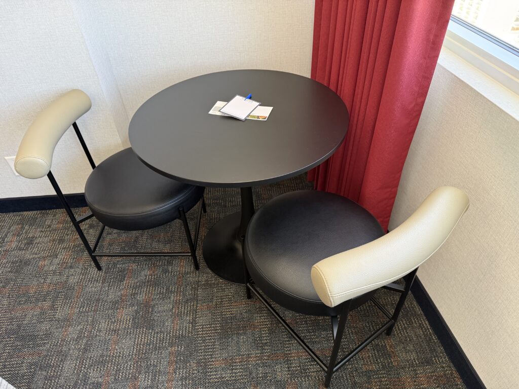 A round black table with two chairs.