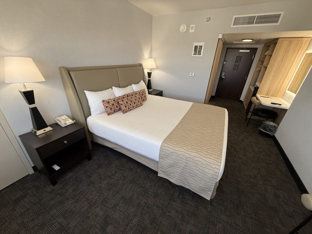 Another angle of the room that shows the bed with the entry to the room in the background.