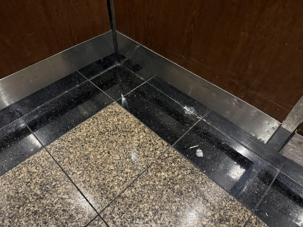 Debris and garbage in the floor of my elevator. 