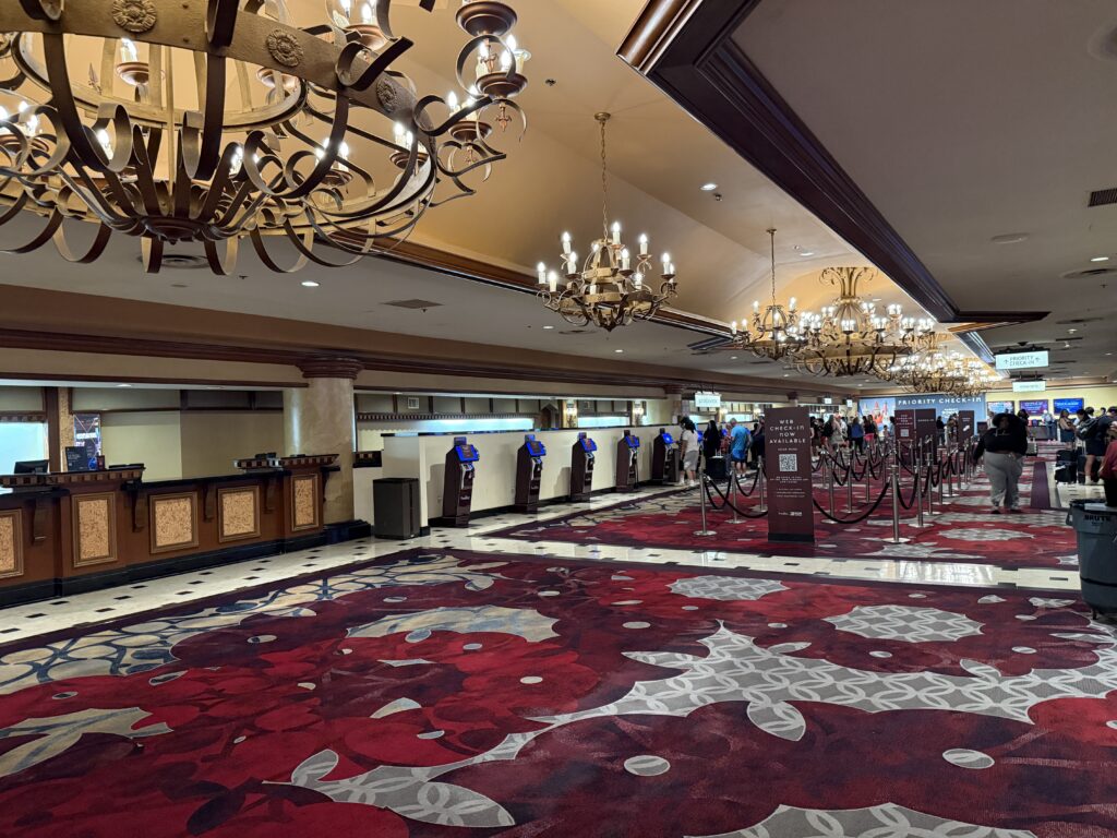 Excalibur's hotel lobby, with castle themed chandeliers hanging above. 
