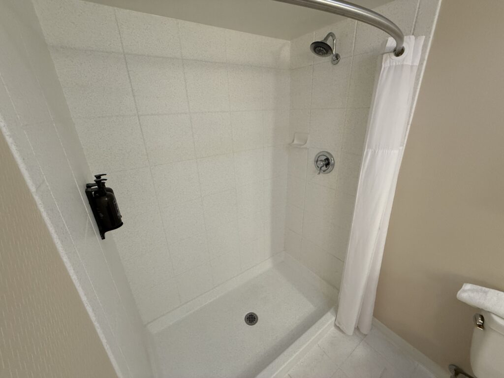 A white walk in shower. 