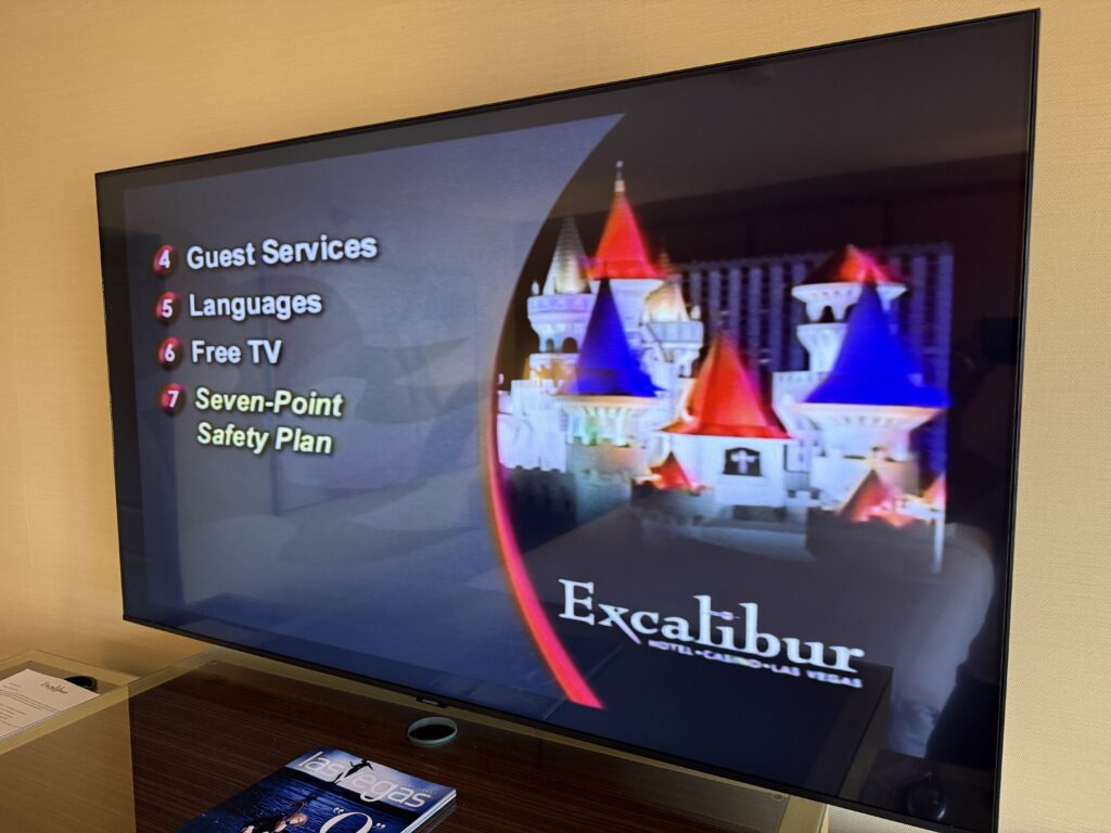 A 55" TV showing a main menu. 